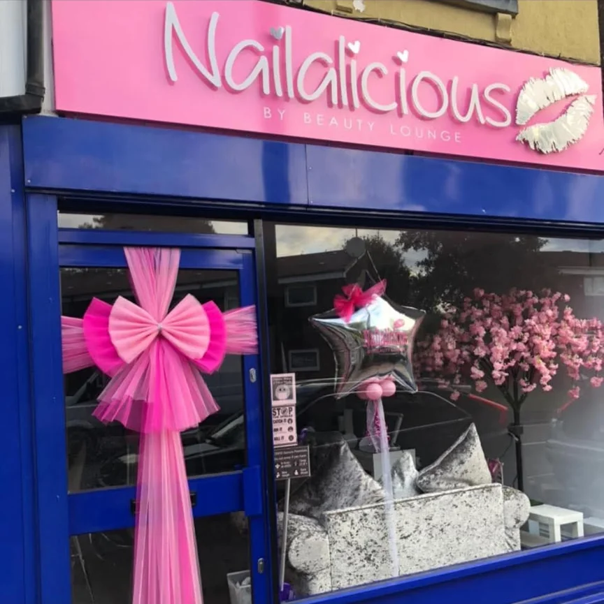 The genuine Nailalicious shopfront with its pink sign and blue entrance on Broad Street