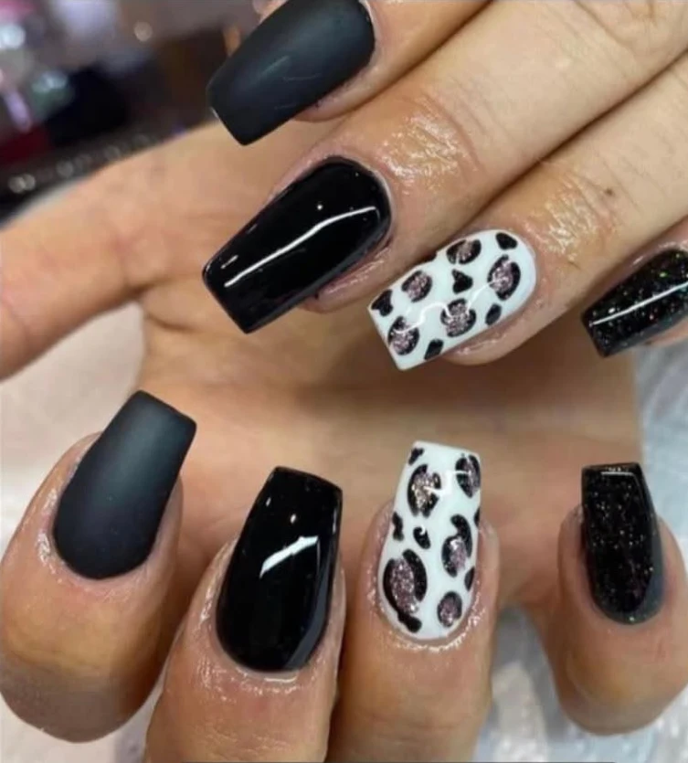 Black matte and glossy nails with leopard-print accents by Nailalicious